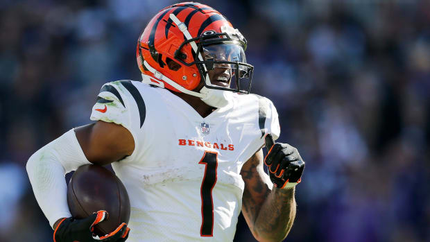 Cincinnati Bengals wide receiver Ja'Marr Chase (1) breaks tackles as he takes a reception 82 yards for a touchdown in the third quarter of the NFL Week 7 game between the Baltimore Ravens